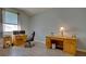 Dedicated home office space with wooden desks, comfortable chair, and natural light for productivity at 802 Eagle Ln, Apollo Beach, FL 33572