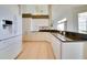 Spacious kitchen with white cabinets, tiled floors, and granite countertops at 802 Eagle Ln, Apollo Beach, FL 33572