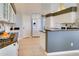 Bright kitchen boasts white cabinets, granite countertops, tiled floors, and modern appliances at 802 Eagle Ln, Apollo Beach, FL 33572