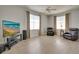 Open living room with wood floors, neutral walls, ceiling fan, and comfortable leather furniture at 802 Eagle Ln, Apollo Beach, FL 33572