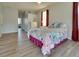 Main bedroom with neutral walls and wood floors leads to the ensuite bathroom at 802 Eagle Ln, Apollo Beach, FL 33572