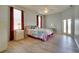 Bright main bedroom with a ceiling fan, neutral walls, and wood floors at 802 Eagle Ln, Apollo Beach, FL 33572