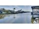 Picturesque waterfront view with private docks, palm trees, and neighboring homes along the serene canal at 802 Eagle Ln, Apollo Beach, FL 33572