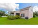 A home's backyard features a screened-in porch and lush green lawn surrounded by mature landscaping at 4135 Rocky Fork Ter, Ellenton, FL 34222