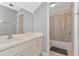 Clean bathroom featuring a vanity with a single sink, a large mirror, and a shower-tub combo for convenience at 4135 Rocky Fork Ter, Ellenton, FL 34222