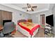 Bedroom with ceiling fan, wood look flooring, and walk-in closet access at 4135 Rocky Fork Ter, Ellenton, FL 34222