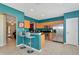 Bright kitchen featuring stainless steel appliances, wooden cabinets, and a breakfast bar with seating for two at 4135 Rocky Fork Ter, Ellenton, FL 34222