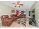 Comfortable living room with leather seating, tiled floors, and an open floor plan to other rooms at 4135 Rocky Fork Ter, Ellenton, FL 34222