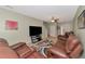 Cozy living room featuring leather furniture, ceiling fan, tiled floors and an entertainment center at 4135 Rocky Fork Ter, Ellenton, FL 34222