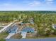 Aerial view of a landscaped property with a backyard pool, surrounded by lush greenery at 11344 Gallinule Ave, Weeki Wachee, FL 34613