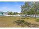 Spacious backyard bordered by mature trees and a white vinyl fence, offering ample room for recreation at 11344 Gallinule Ave, Weeki Wachee, FL 34613