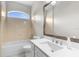 Bright bathroom featuring a tub, shower, and a vanity with a large mirror and modern fixtures at 11344 Gallinule Ave, Weeki Wachee, FL 34613