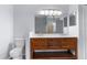 Bathroom with double sink vanity, ample lighting, and lots of storage at 11344 Gallinule Ave, Weeki Wachee, FL 34613