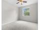 Well-lit bedroom boasts plush carpeting and a large window, offering a bright and airy space to unwind at 11344 Gallinule Ave, Weeki Wachee, FL 34613