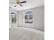 Bright bedroom with pool view, ceiling fan, and sliding glass doors to backyard at 11344 Gallinule Ave, Weeki Wachee, FL 34613