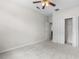 Well-lit bedroom features plush carpet, ceiling fan and a closet with a white bifold door at 11344 Gallinule Ave, Weeki Wachee, FL 34613