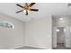 Neutral bedroom with ceiling fan and doorway to bathroom at 11344 Gallinule Ave, Weeki Wachee, FL 34613