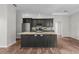 Kitchen featuring stainless steel appliances and a large island with a stone countertop at 11344 Gallinule Ave, Weeki Wachee, FL 34613