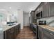 Kitchen featuring stainless steel appliances, a sink under the window, and dark wood cabinets at 11344 Gallinule Ave, Weeki Wachee, FL 34613