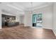 Bright living room featuring hardwood floors and sliding glass doors to the pool area at 11344 Gallinule Ave, Weeki Wachee, FL 34613