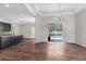 Bright living room featuring hardwood floors and sliding glass doors to the pool area at 11344 Gallinule Ave, Weeki Wachee, FL 34613