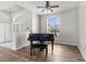 Living room with hardwood floors featuring a baby grand piano and lots of natural light at 11344 Gallinule Ave, Weeki Wachee, FL 34613