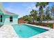 Refreshing pool with blue water is surrounded by stone pavers and landscaping, creating a private backyard oasis at 11344 Gallinule Ave, Weeki Wachee, FL 34613