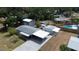 Expansive aerial view of home highlighting pool, carport, and additional storage outbuilding at 4125 Worcester Rd, Sarasota, FL 34231