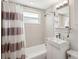 Bright bathroom featuring a stylish vanity, modern fixtures, and shower with striped curtain at 4125 Worcester Rd, Sarasota, FL 34231