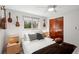 Charming bedroom with a bed, window, closet, and hanging decorative guitars at 4125 Worcester Rd, Sarasota, FL 34231