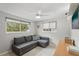 Light-filled bedroom with a cozy gray couch, ceiling fan, and ample natural light at 4125 Worcester Rd, Sarasota, FL 34231
