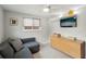 Inviting den area with a comfortable couch, window, dresser and mounted television at 4125 Worcester Rd, Sarasota, FL 34231