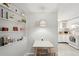 Cozy dining area complemented by a modern light fixture and shelves for a homey feel at 4125 Worcester Rd, Sarasota, FL 34231