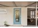 Close up of the home's blue-painted doorway leading to the screened in porch at 4125 Worcester Rd, Sarasota, FL 34231