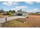A charming home features a screened-in patio, carport and brick driveway at 4125 Worcester Rd, Sarasota, FL 34231
