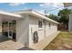 The exterior features a pebble path, hose, and screened-in area for easy maintenance at 4125 Worcester Rd, Sarasota, FL 34231