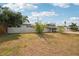 Lush front yard of a home featuring a well-kept fence and attractive landscaping on a sunny day at 4125 Worcester Rd, Sarasota, FL 34231