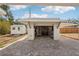 Garage exterior featuring an adjacent shed and paver driveway at 4125 Worcester Rd, Sarasota, FL 34231