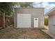 Steel building featuring a rolling door and additional access door at 4125 Worcester Rd, Sarasota, FL 34231