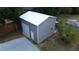 New detached garage featuring roll-up door, pedestrian door, and exterior lighting at 4125 Worcester Rd, Sarasota, FL 34231
