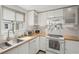 Bright kitchen featuring butcher block countertops, sleek white cabinets and a stainless steel sink at 4125 Worcester Rd, Sarasota, FL 34231