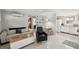 Open-concept living room boasts sleek flooring, and a seamless transition to the kitchen and dining area at 4125 Worcester Rd, Sarasota, FL 34231
