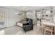 Sunlit living room with sleek floors, and views of dining area at 4125 Worcester Rd, Sarasota, FL 34231