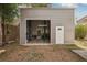 Exterior shot of outbuilding; includes a door and lift inside the building at 4125 Worcester Rd, Sarasota, FL 34231
