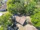 A high angle shot of the roof of a house and surrounding trees and neighborhood at 6175 Beechwood Dr, Dade City, FL 33523