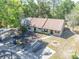 Aerial view of home featuring driveway, carport, green landscaping, and tree coverage at 6175 Beechwood Dr, Dade City, FL 33523