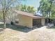 Rear exterior view of a well-maintained home with a screened-in porch at 6175 Beechwood Dr, Dade City, FL 33523
