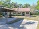 Charming single-story home featuring a carport, landscaped yard, and neutral exterior paint at 6175 Beechwood Dr, Dade City, FL 33523