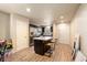 Open kitchen with a large island, wooden stools, stainless steel appliances, and wood floors at 6175 Beechwood Dr, Dade City, FL 33523
