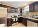 Modern kitchen featuring stainless steel appliances and rich wooden cabinetry at 6175 Beechwood Dr, Dade City, FL 33523
